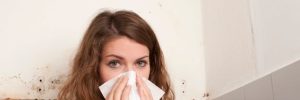 woman with handkerchief in front of a mold spot